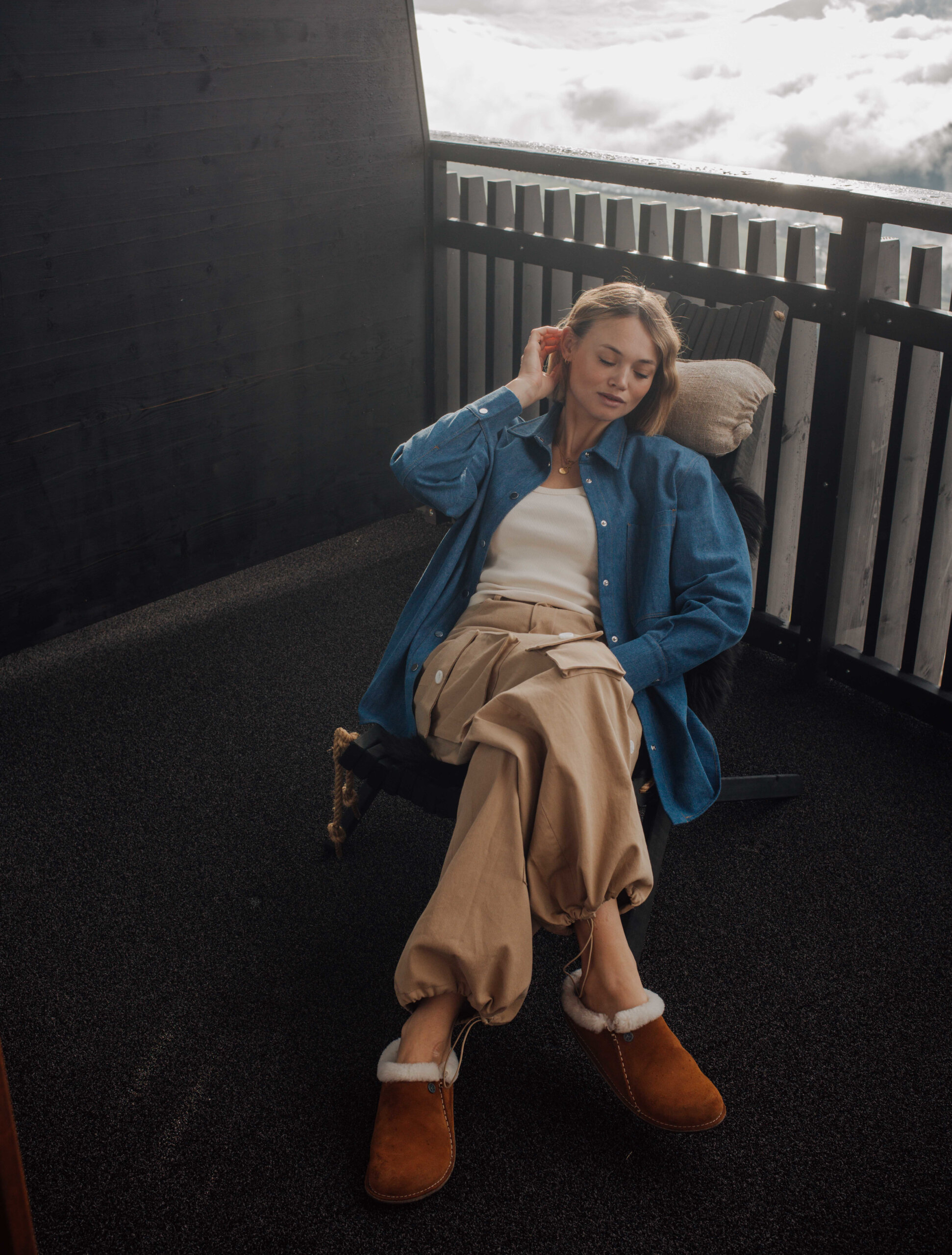 Frau sitzt im Stuhl auf dem Balkon - Hotel Familiamus